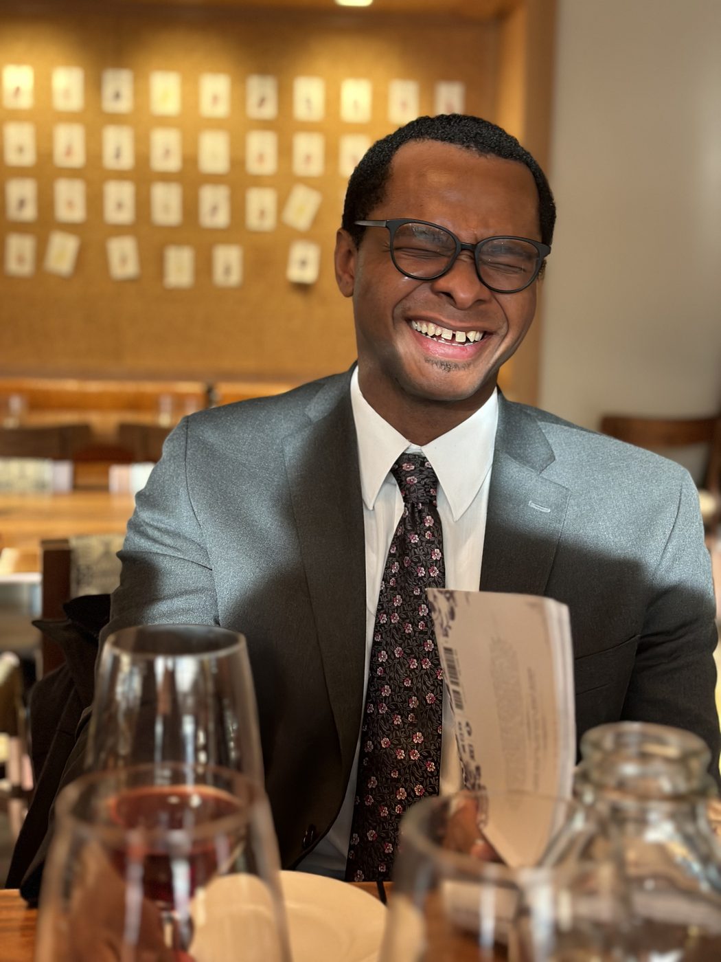 A guest laughing over a glass of wine during a tasting